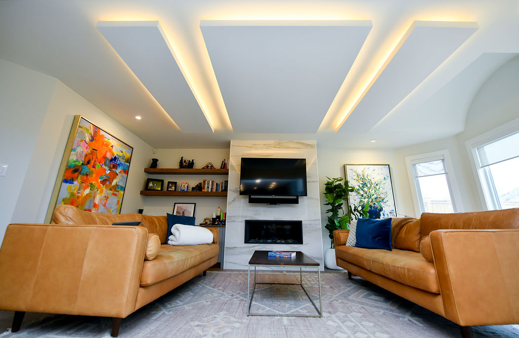 fireplace tile surround, new flooring, fireplace cabinets, art work, false ceiling lighting
